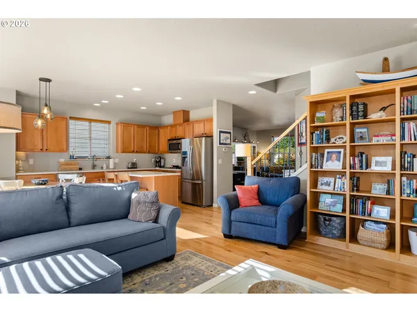 a living room with furniture and a book shelf