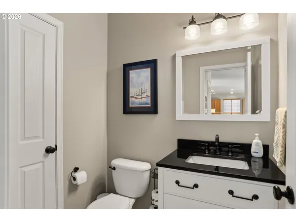 a bathroom with a sink a mirror and a toilet