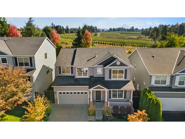 a aerial view of a house next to a yard
