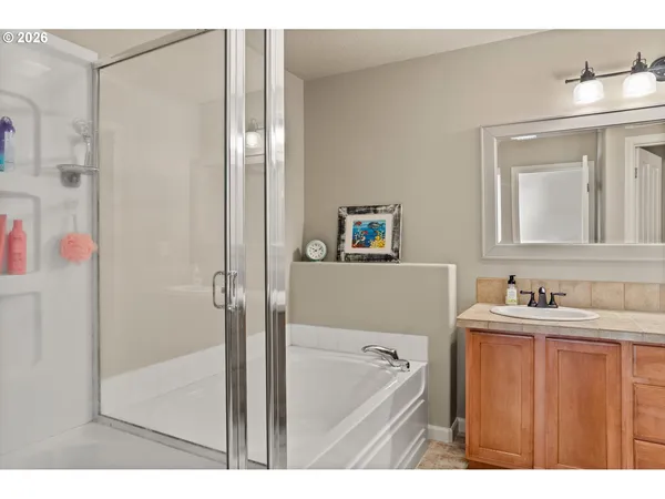 a bathroom with a tub sink and mirror