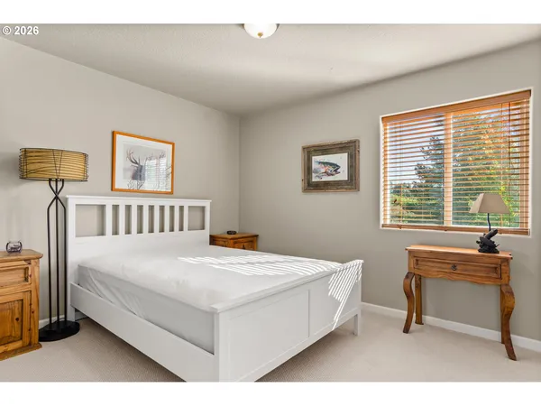 a bedroom with a bed a table and a window
