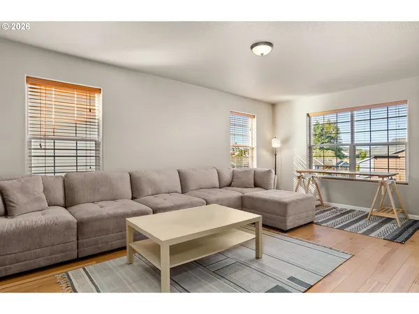 a living room with a bed furniture and a flat tv screen
