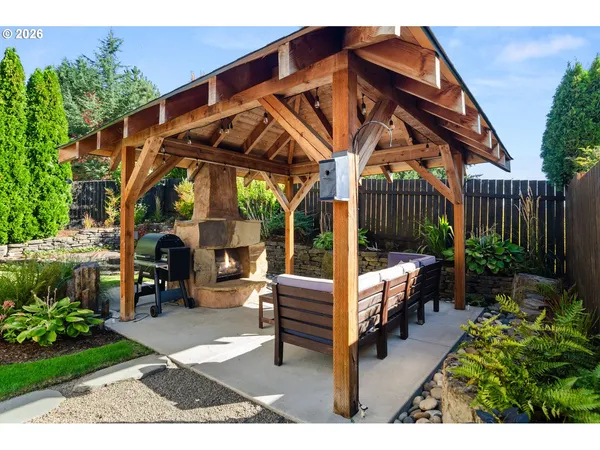 a backyard of a house with table and chairs