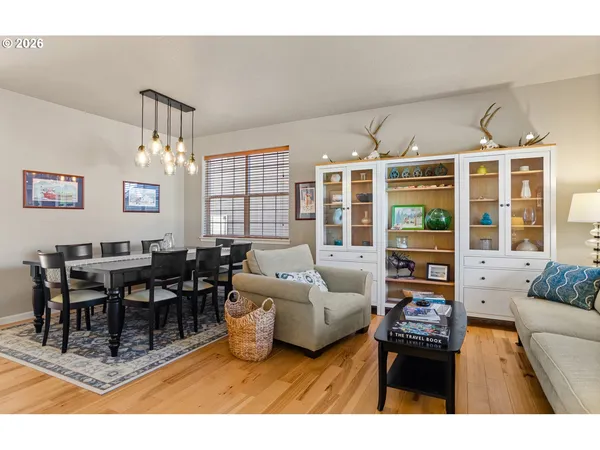 a living room with furniture a chandelier and a dining table