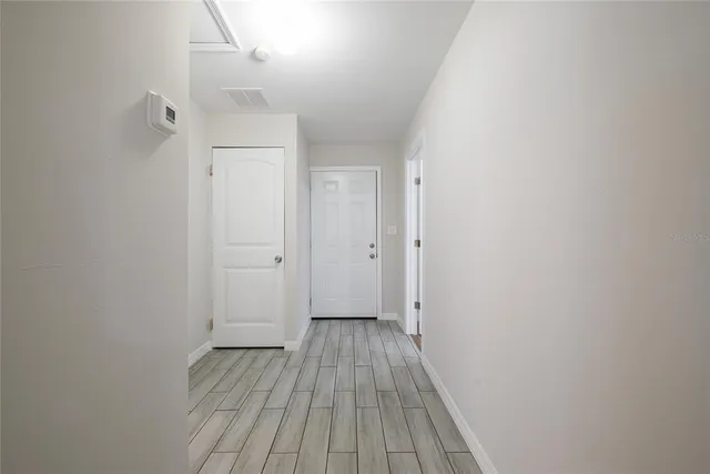 a view of a room with wooden floor