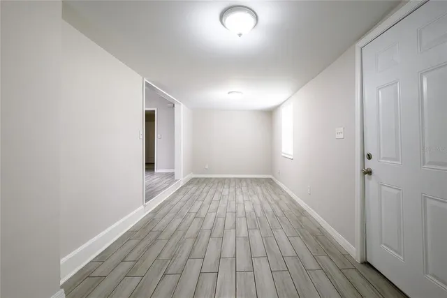wooden floor in an empty room with a window