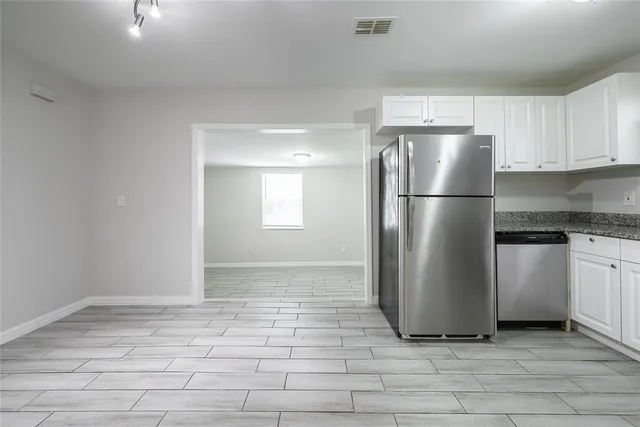 a kitchen with a refrigerator a stove top oven a sink and dishwasher