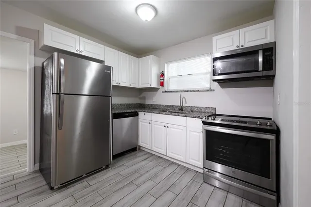 a kitchen with a refrigerator stove and microwave