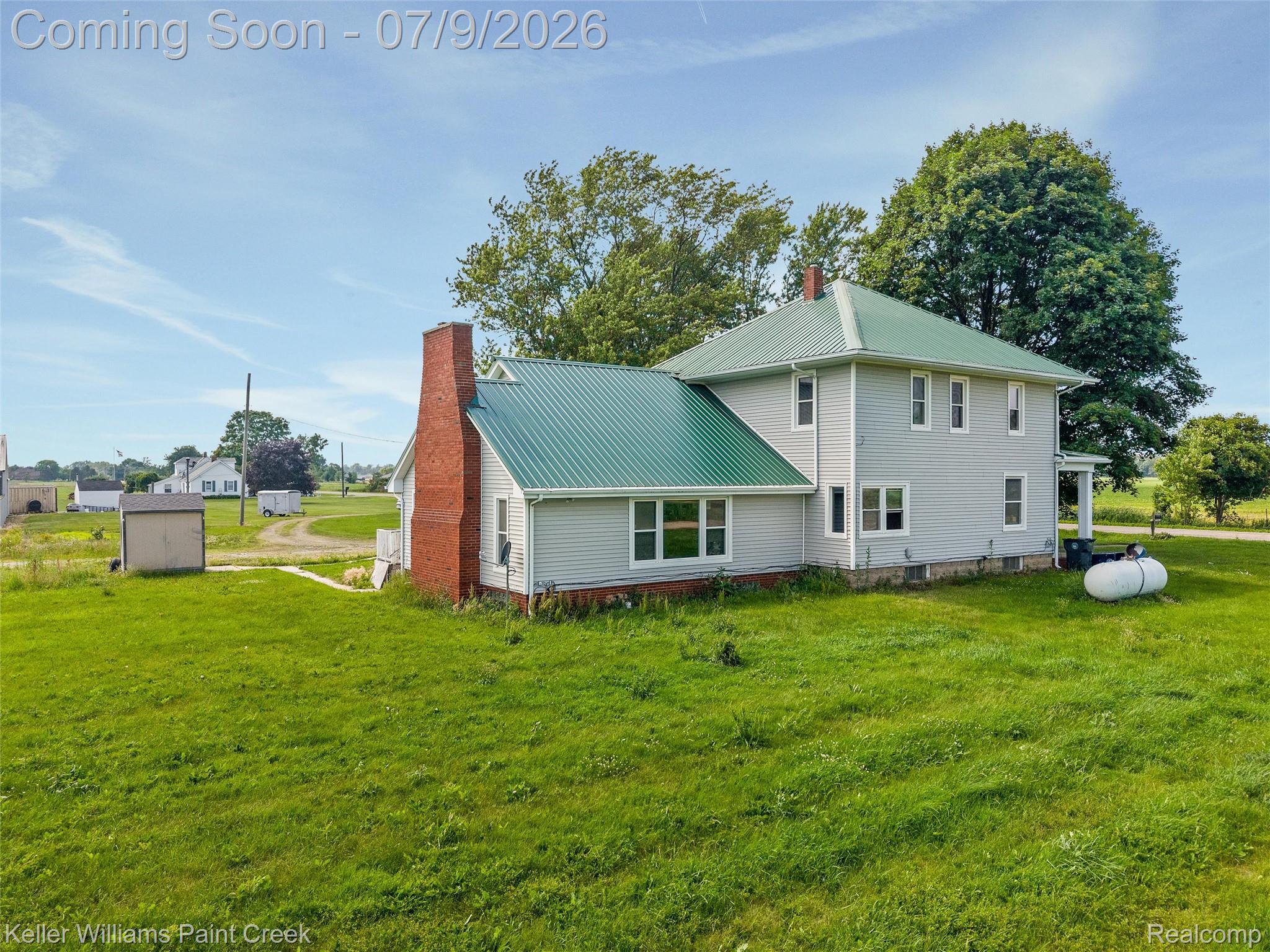 28780 School Section Road Richmond, MI 48062 - Photo 44 of 50 Traditional light gray siding exterior with a vibrant green metal roof