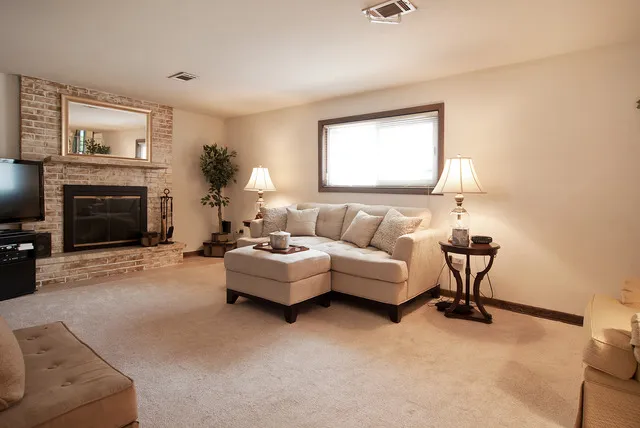 a living room with furniture and a fireplace