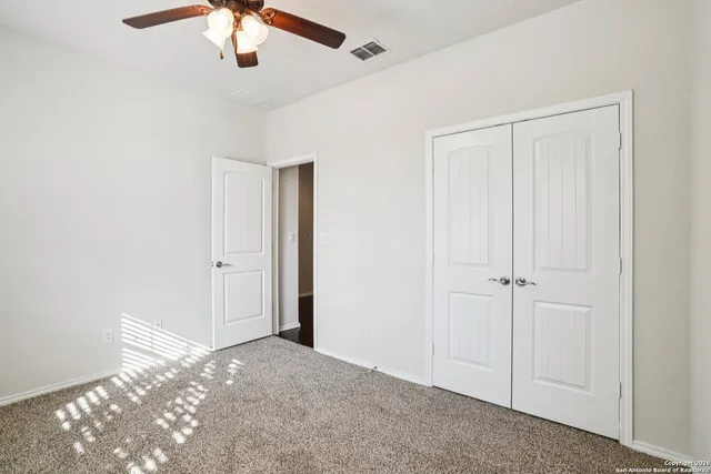 a view of a livingroom with a chandelier fan
