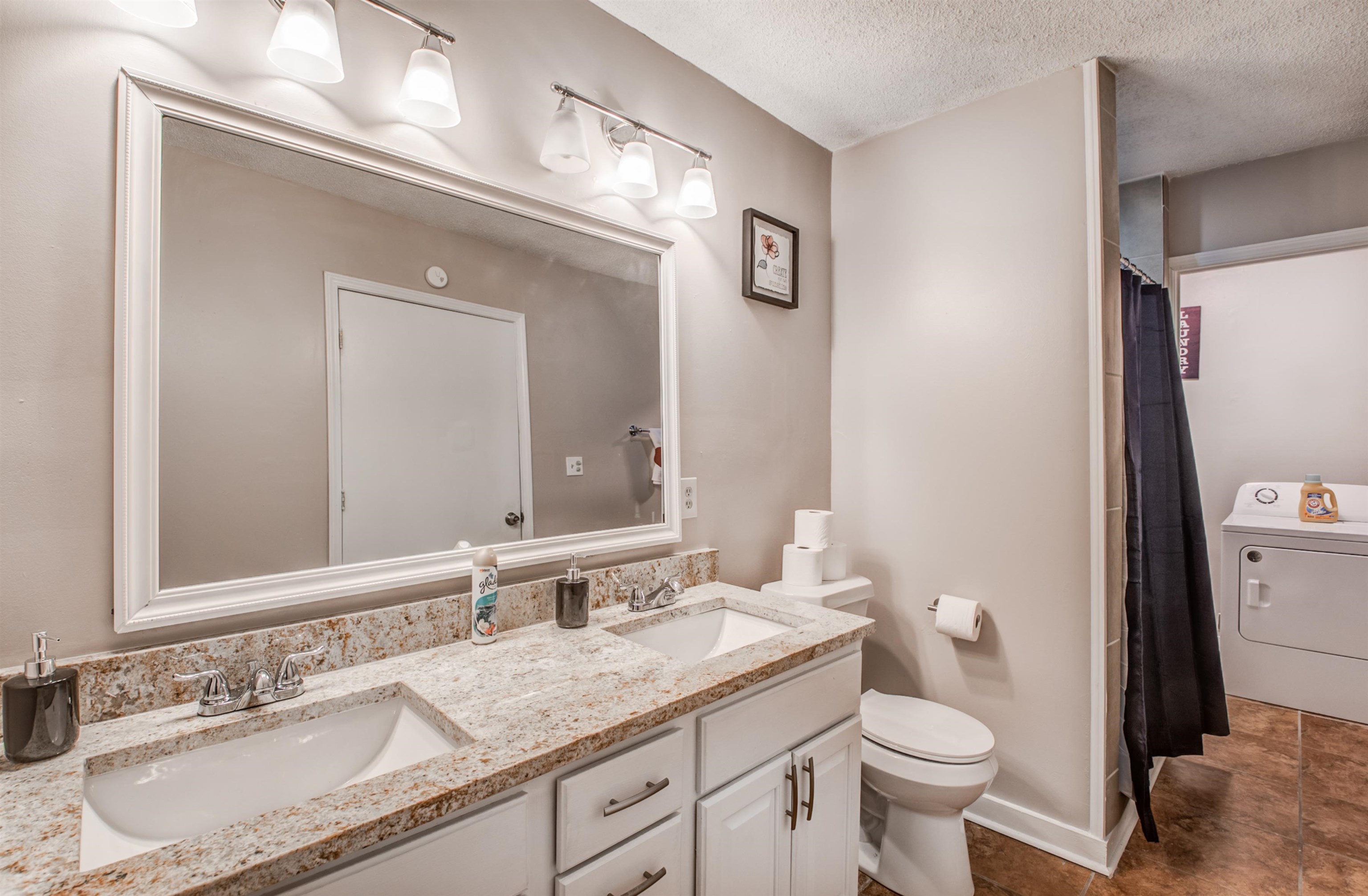 4850 Flamingo Road Memphis, TN 38117 - Photo 26 of 40 Full bathroom with washer / dryer, double vanity, a textured ceiling, and a shower with curtain