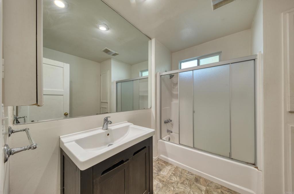 444 North Myrtle Avenue Monrovia, CA 91016 - Photo 9 of 37 a bathroom with a sink a mirror and a shower