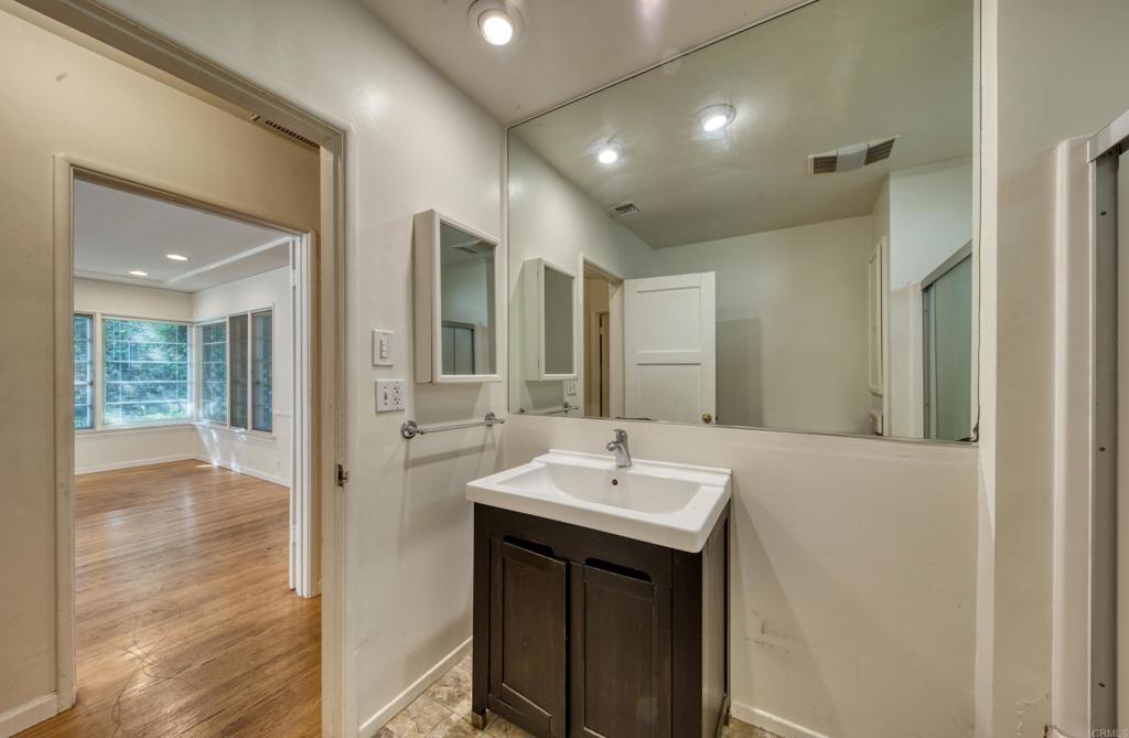 444 North Myrtle Avenue Monrovia, CA 91016 - Photo 10 of 37 a bathroom with a sink a large mirror and a shower