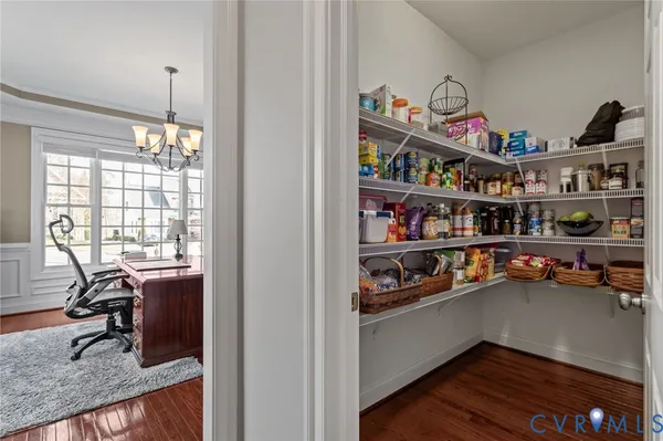 a kitchen with stainless steel appliances granite countertop a stove a sink dishwasher a refrigerator white cabinets with wooden floor