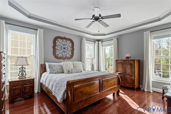 a bedroom with a large bed and a chandelier