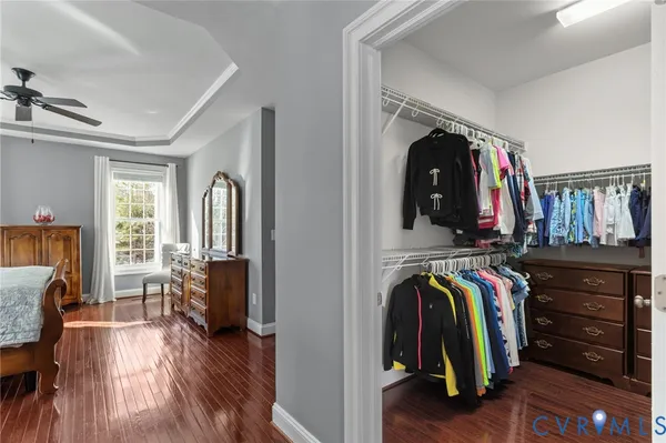 a view of walk in closet with clothes