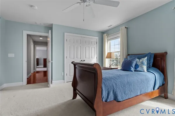 a bathroom with a granite countertop toilet sink and mirror