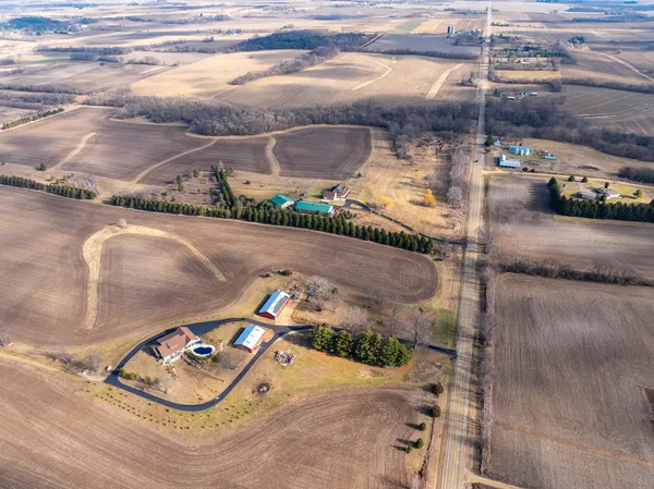 an aerial view of a house a yard and lake view