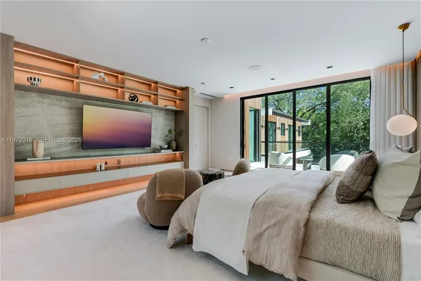 a bedroom with two beds and a flat screen tv