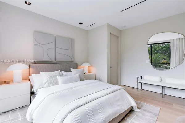 a bedroom with bed and window