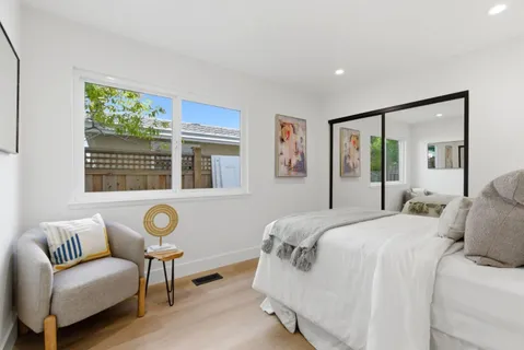 a bedroom with a bed and a couch