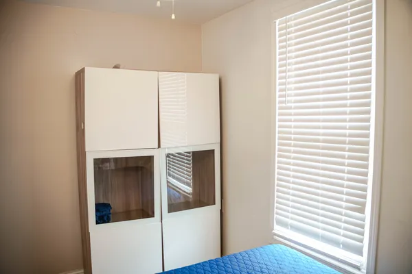 a kitchen with a window and wooden floor