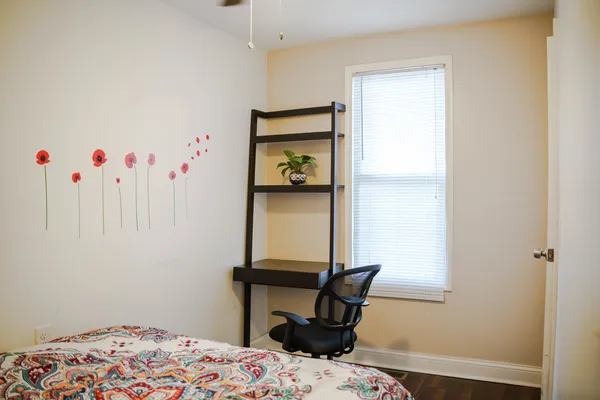 a bedroom with a bed and a table in it