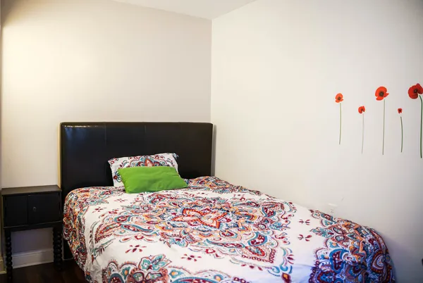 a bedroom with a bed and wooden floor
