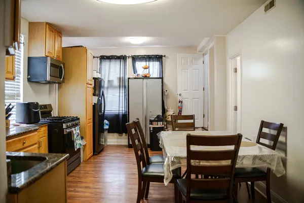 a view of a dining room with furniture and wooden floor