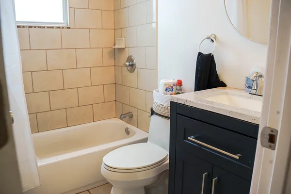 a bathroom with a sink a toilet and bathtub