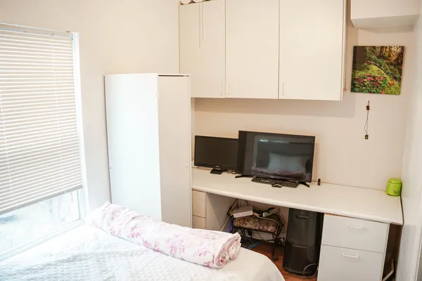 a bedroom with a bed and a flat screen tv