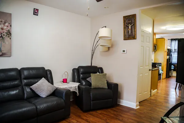 a living room with furniture and a wooden floor