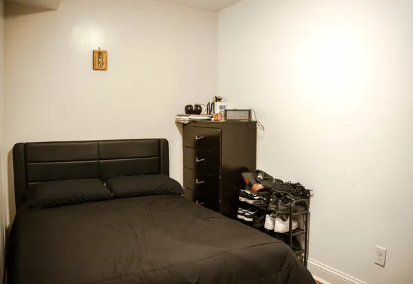 a bedroom with a bed and a chair