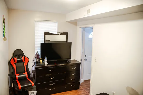 a living room with furniture and flat screen tv