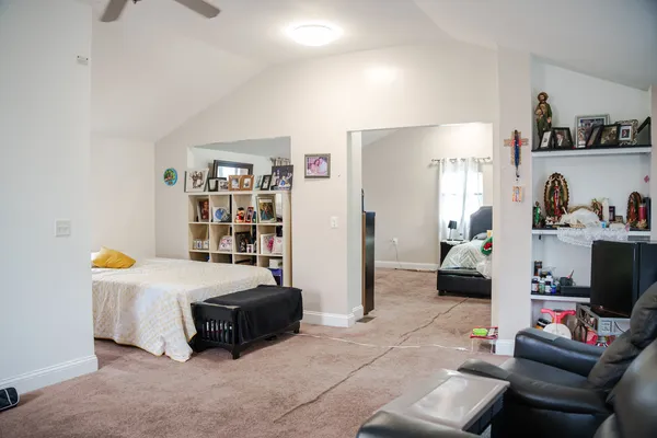 a bedroom with furniture and a flat screen tv