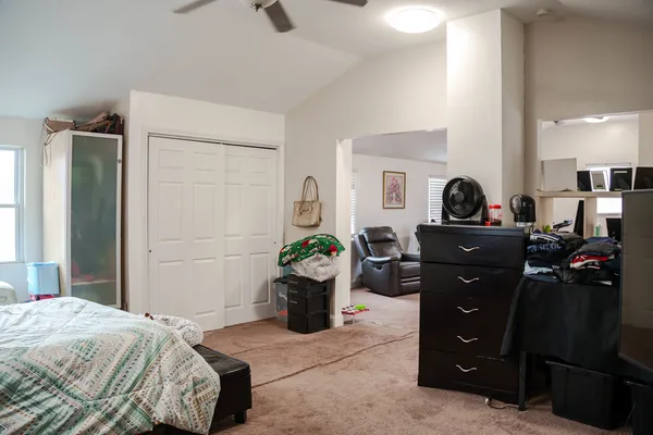 a bedroom with a bed and a dresser