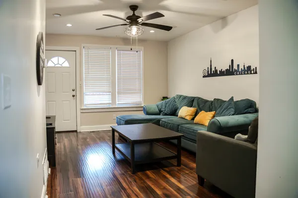 a living room with furniture and a wooden floor