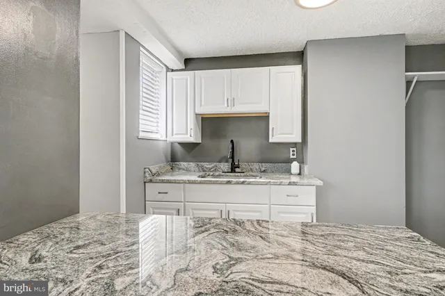 a room with a bed and a dresser