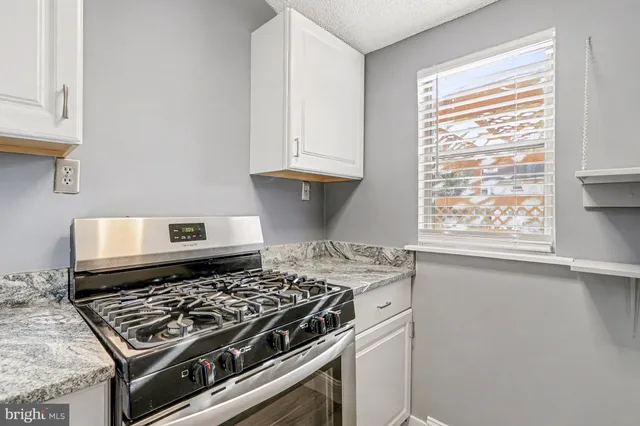 a stove top oven sitting inside of a kitchen