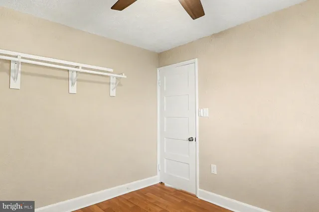 a view of walk in closet with wooden floor