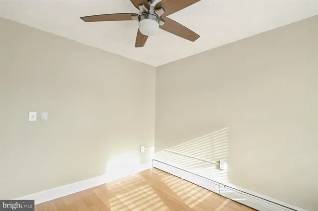 a view of a room with a ceiling fan