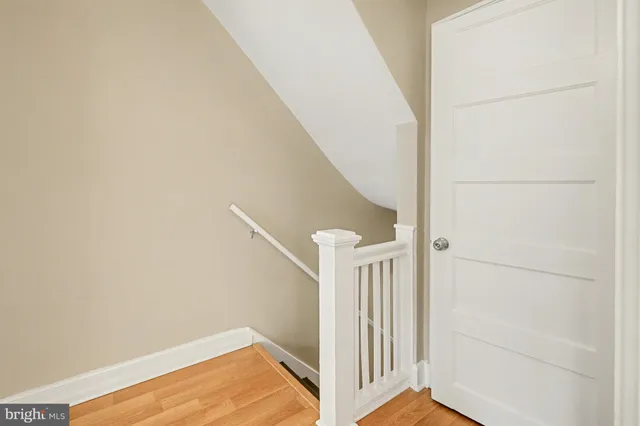 a view of a big room with wooden floor and windows