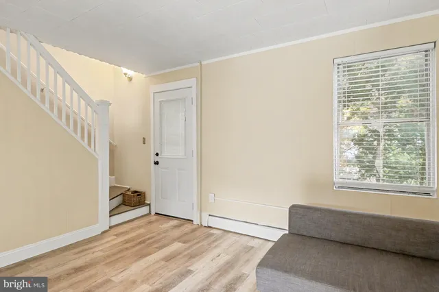 a view of room with window and hardwood floor