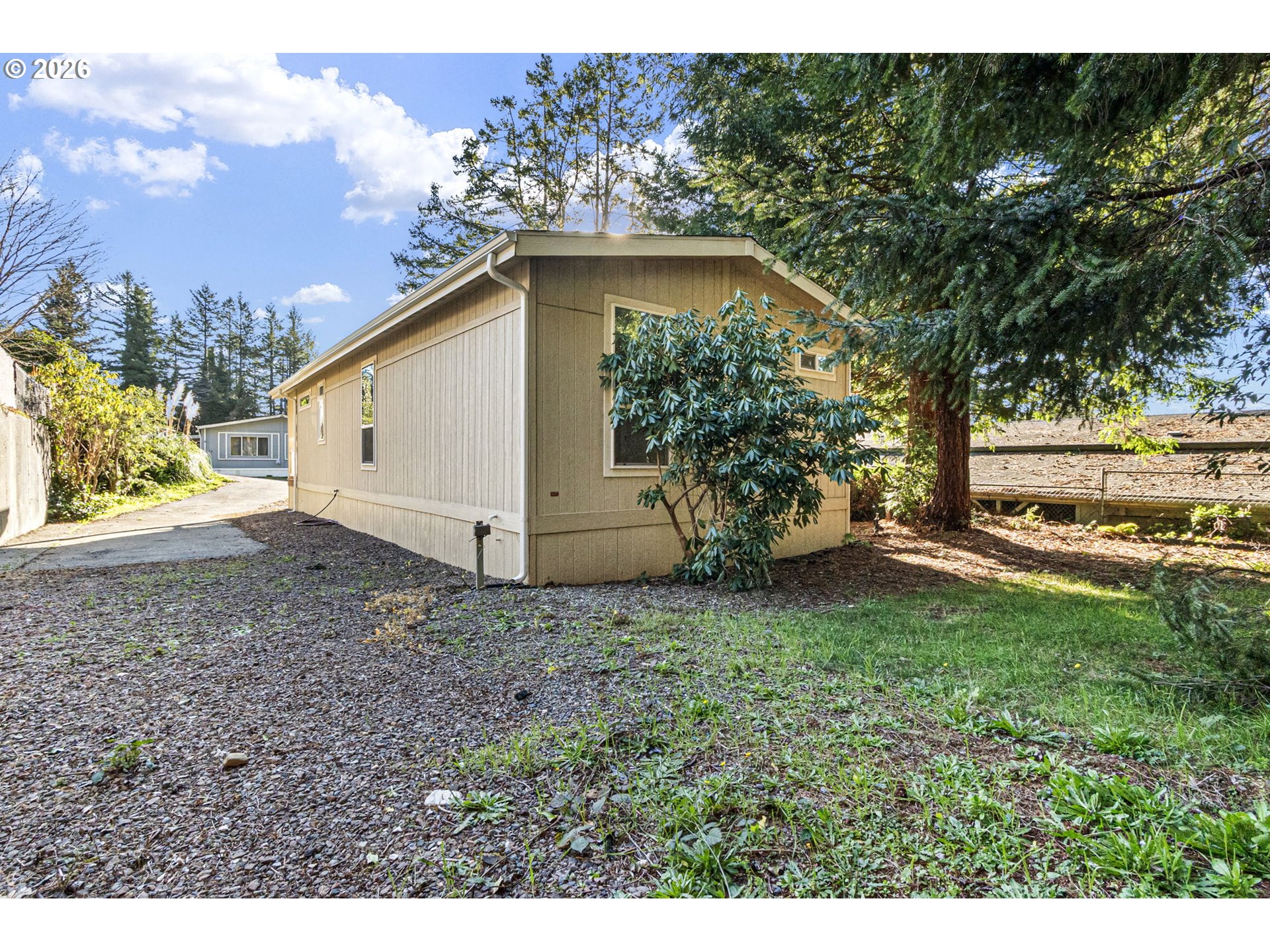 98041 Hallway Road, Unit 19 Brookings, OR 97415 - Photo 18 of 20 a view of a backyard with a garden and entertaining space