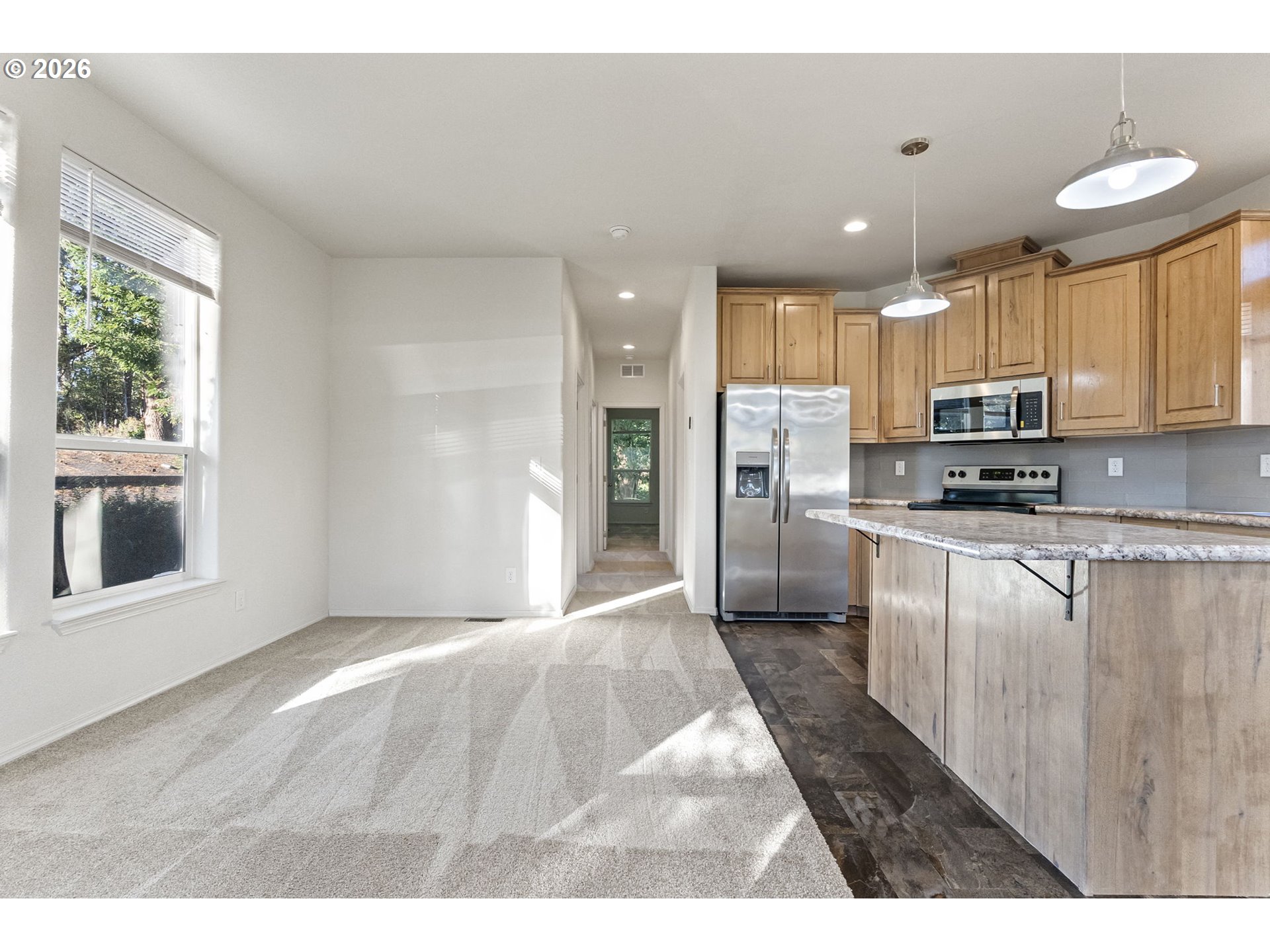 98041 Hallway Road, Unit 19 Brookings, OR 97415 - Photo 3 of 20 a kitchen with stainless steel appliances granite countertop a stove a sink and a refrigerator
