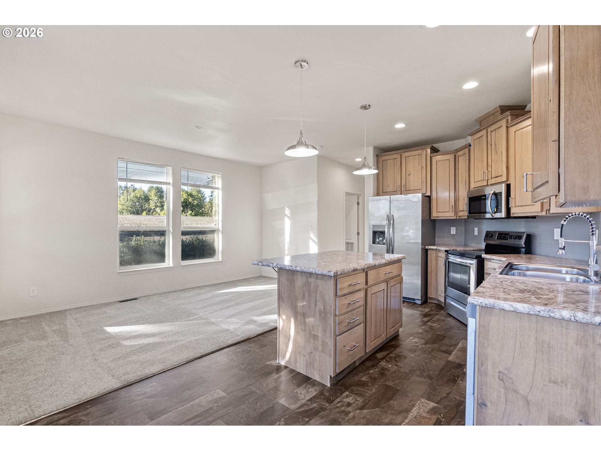 98041 Hallway Road, Unit 19 Brookings, OR 97415 - Photo 6 of 20 a open kitchen with kitchen island a sink stove and white cabinets