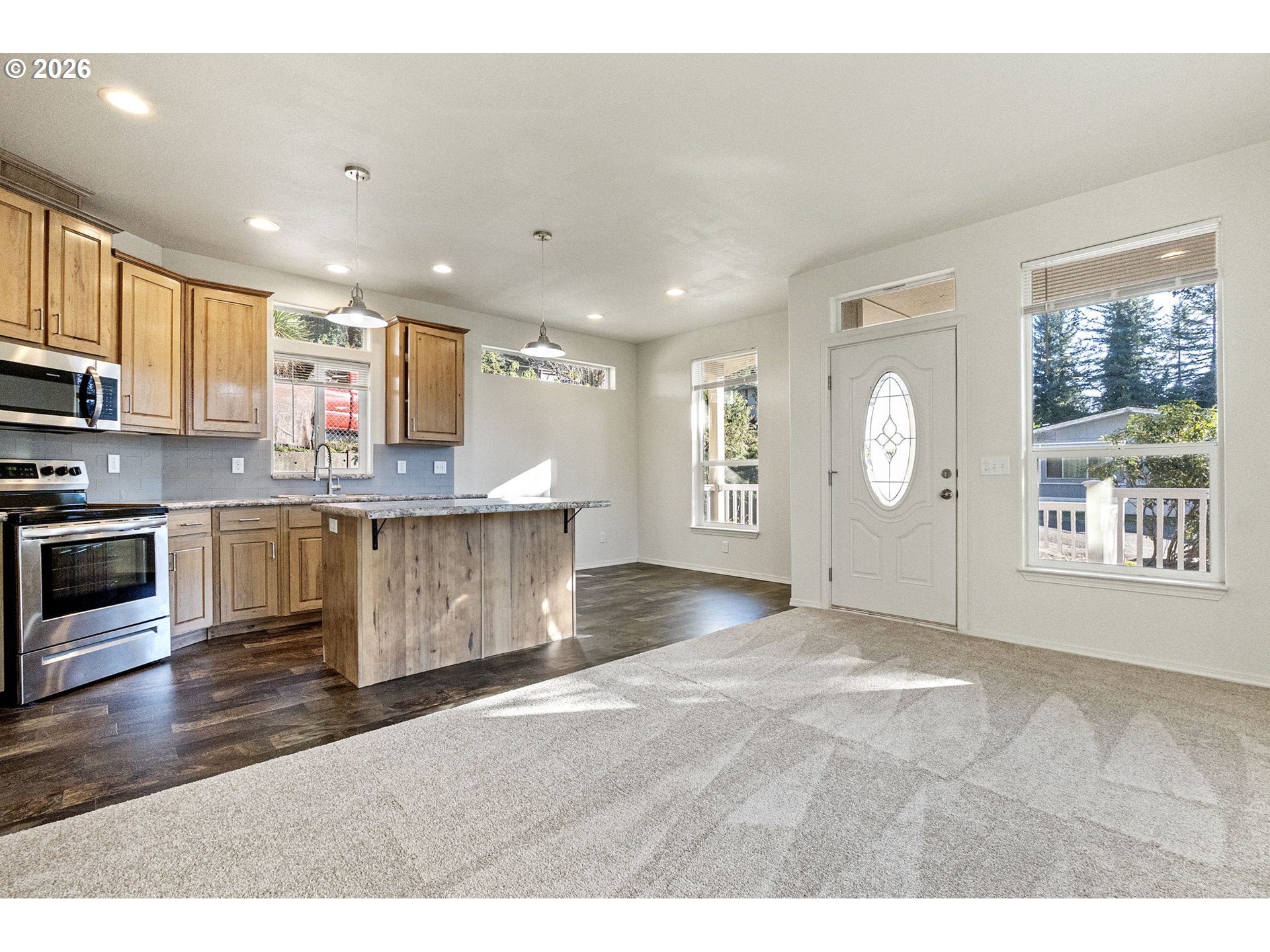 98041 Hallway Road, Unit 19 Brookings, OR 97415 - Photo 7 of 20 a large kitchen with stainless steel appliances granite countertop a large window