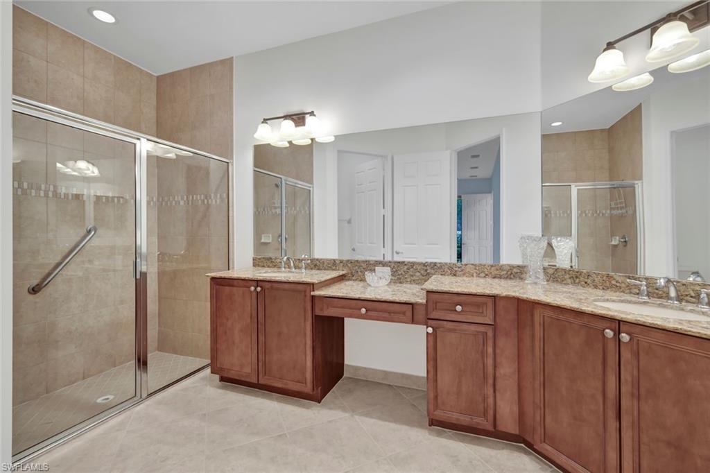 6526 Monterey Point, Unit 101 Naples, FL 34105 - Photo 13 of 20 a bathroom with a granite countertop double vanity sink and mirror