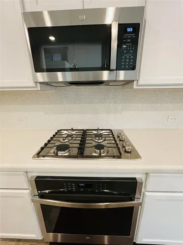 a stove top oven sitting inside of a kitchen